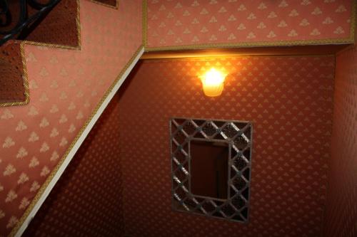 a room with a window and a light on the wall at Ca' Pedrocchi in Venice