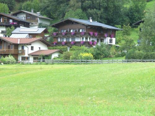 a large house with flowers on it in a field at Rosi`s in Maria Alm am Steinernen Meer