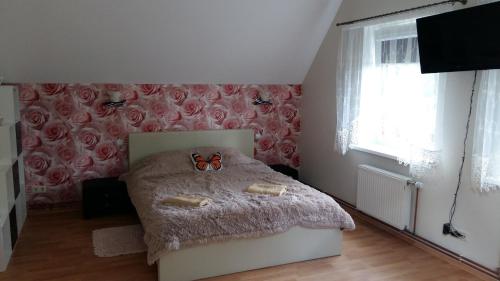 a bedroom with a bed with a pair of glasses on it at Holiday Home Ermine in Sigulda