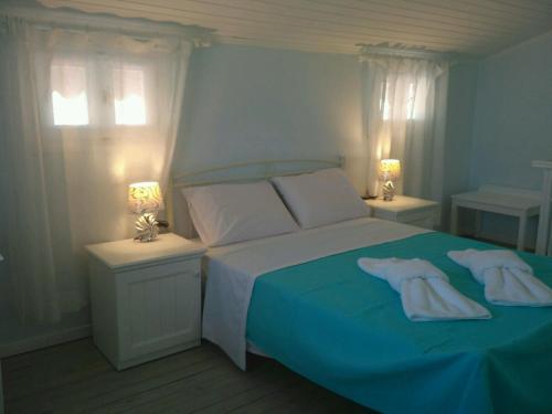 a bedroom with a bed with two towels on it at Sofia-Irini in Kalamaki Heraklion