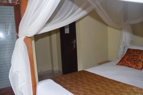a bedroom with a bed with a canopy at Ubud Sawah Scenery Villa and Homestay in Tegalalang