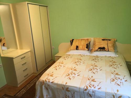 a bedroom with a bed and a dresser at Apartment Elena in Sandanski