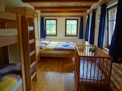 a room with two bunk beds and two windows at Penzion Pod Kopcem in Janov nad Nisou