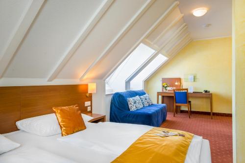 En eller flere senge i et værelse på Hotel Rega Stuttgart
