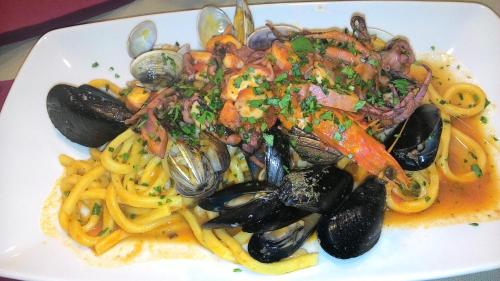 un plato de pasta y marisco con mejillones y carne en Casa vacanze The Flea's Home, en Fondi