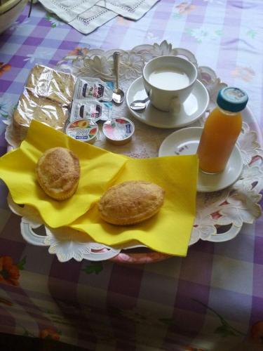 a table with a plate of food and a cup of coffee at Agriturismo Tenuta Perruzzi in Leverano