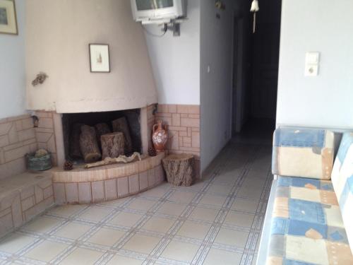 a living room with a brick fireplace in a room at Villa Marita in Lisvórion