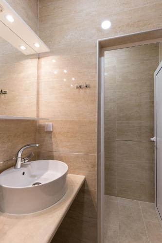 a bathroom with a sink and a shower at Hostel Free Bird in Dubrovnik