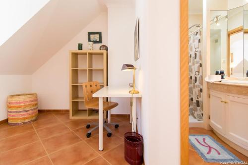 an attic office with a desk and a sink at Gomes Freire Terrace in Cascais