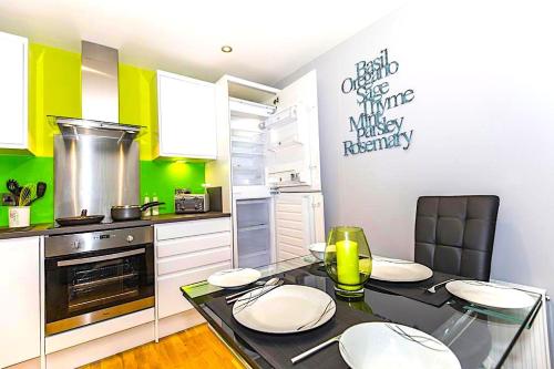 a kitchen with a table with four chairs and a stove at Pullman House in Darlington