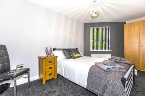 a bedroom with a bed and a desk and a chair at Pullman House in Darlington
