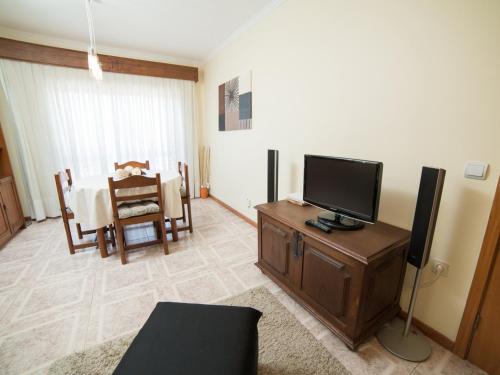 a living room with a television and a dining room at OPORTO GUEST Vila do Conde River & Sea in Vila do Conde