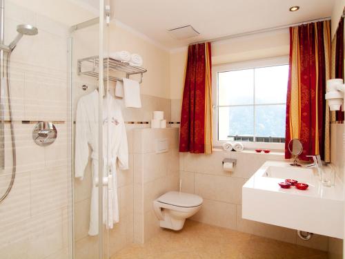 a bathroom with a toilet and a shower and a sink at Romantica Schlössl in Fiss