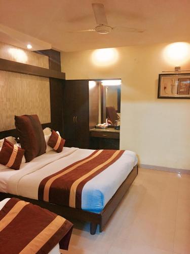 a bedroom with a large bed in a room at Hotel CJ International in Amritsar
