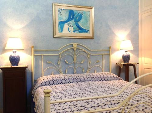 a bedroom with a white bed and two lamps at Anticadimora Dei Pepe in Salve