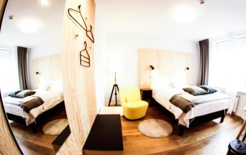 a bedroom with two beds and a mirror at Hemma rooms by IKEA in Zbąszyń