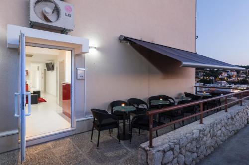 a restaurant with black chairs and tables and a bar at Hostel Free Bird in Dubrovnik