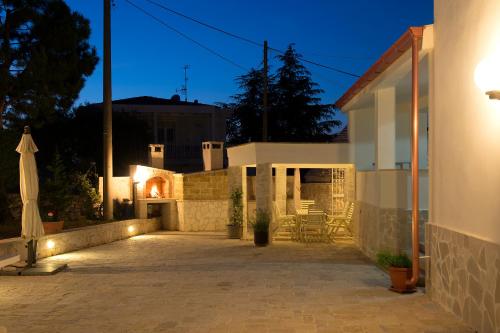 a house with a patio at night with lights at Trullo suite 59 in Noci