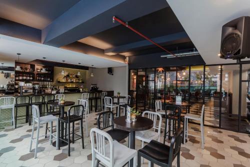 a restaurant with tables and chairs and a bar at Verdant Hill Hotel Kuala Lumpur in Kuala Lumpur