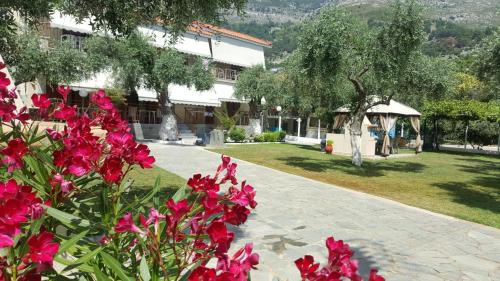 a garden with pink flowers in front of a building at Holiday Villa Thassos in Koinyra