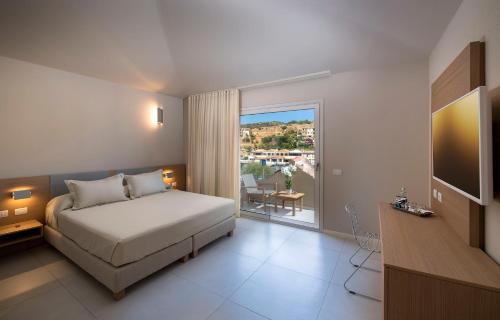 a hotel room with a bed and a balcony at Domu Simius Life Style Hotel in Villasimius