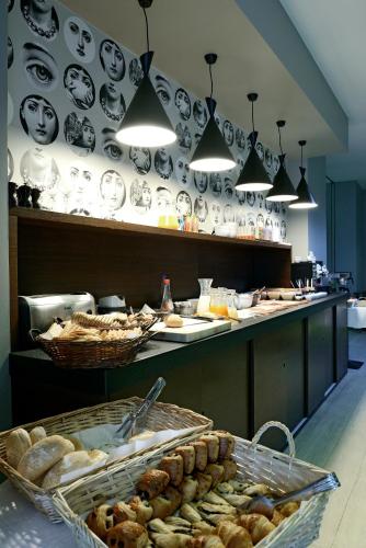 a bakery with a counter with plates on the wall at Square Hotel in Kortrijk