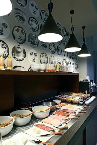 a buffet line with bowls and plates of food at Square Hotel in Kortrijk