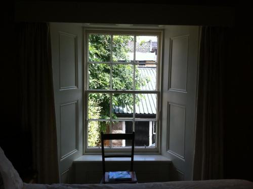 a room with a chair and a window at Bankfoot Inn in Bankfoot
