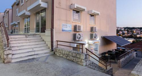 a building with stairs on the side of it at Hostel Free Bird in Dubrovnik