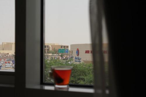 a glass of wine sitting on a window sill at Unique Suites in Riyadh