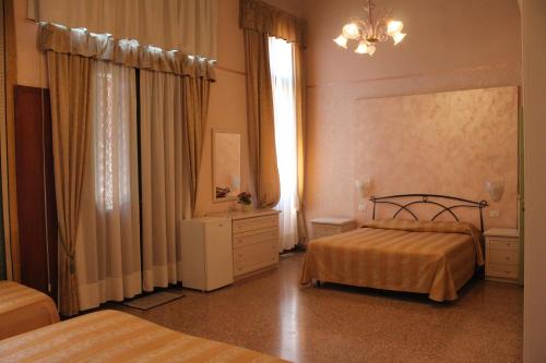 Habitación de hotel con 2 camas y espejo en Palazzo Lion Morosini - Check in presso Locanda Ai Santi Apostoli, en Venecia