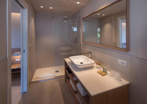 a bathroom with a sink and a shower at Domu Simius Life Style Hotel in Villasimius