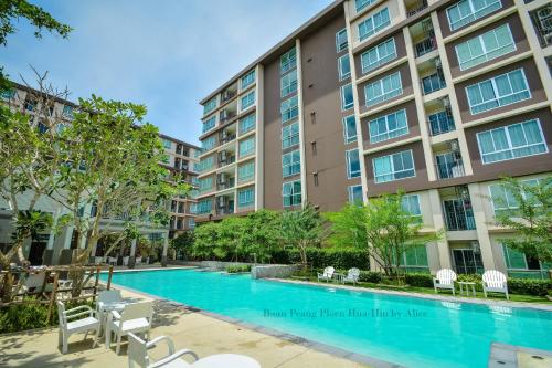 a swimming pool in front of a building at Baan Peang Ploen Huahin by Alice in Hua Hin