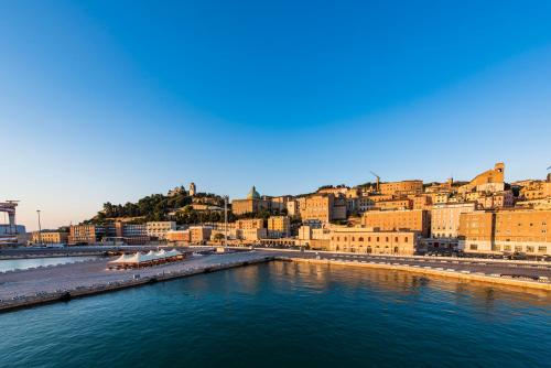 a view of a city with a river and buildings at Grand Hotel Palace in Ancona