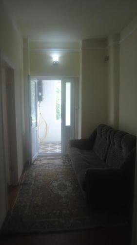 a living room with a couch and an open door at Maka & Khato in Kazbegi in Stepantsminda