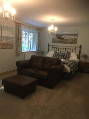 a living room with a couch and a bed at The Waterwheel in St Austell
