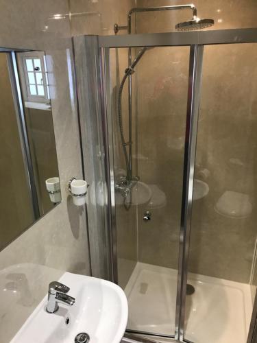 a bathroom with a shower and a sink at The Waterwheel in St Austell