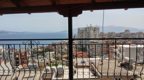 a balcony with chairs and a view of a city at Elena Apartament in Sarandë