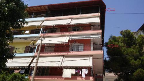 a building with balconies on the side of it at Elena Apartament in Sarandë