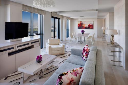 a living room with a couch and a tv at Hyatt Regency Creek Heights Residences in Dubai