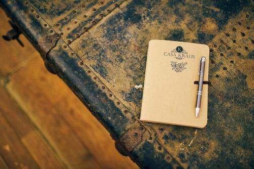 a notebook with a pen on top of a table at Casa Kraus in Criţ