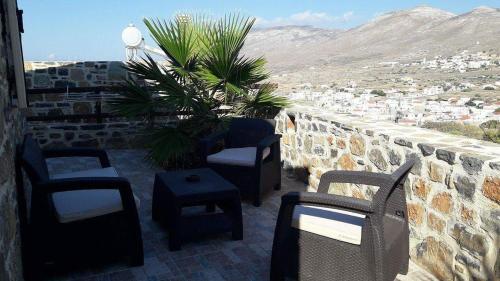 a group of chairs and tables on a patio at Amfi Sea View in Frý