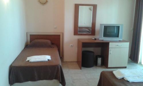 a hotel room with two beds and a television at Hotel Bellisimo in Lozenets