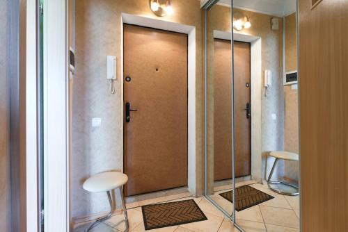 a door in a room with two stools in front of it at Home Hotel Apartments on Livoberezhna in Kyiv