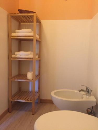 a bathroom with a sink and a toilet and a towel rack at Appartamenti Edvina in Baveno