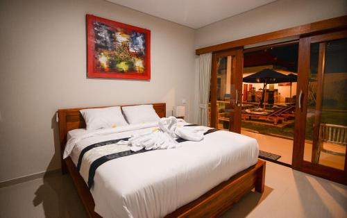 a bedroom with a bed with towels on it at Pondok Canggu Homestay in Canggu