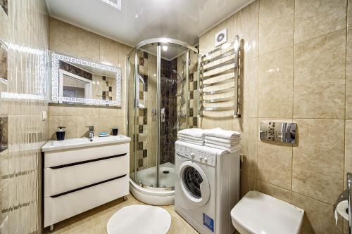 ein Badezimmer mit einer Waschmaschine und einer Waschmaschine in der Unterkunft American Apartment in Lwiw