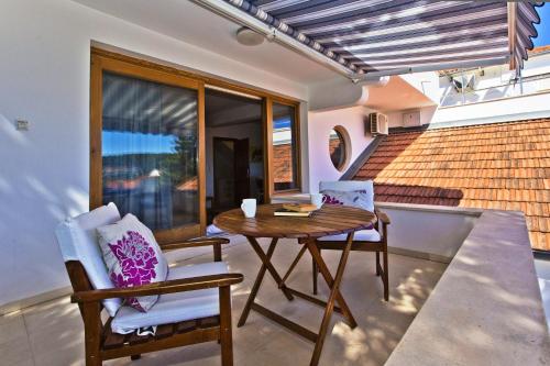 a dining room with a table and two chairs at Castle Štambuk in Hvar