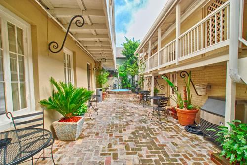 a patio with chairs and tables on a building at Inn on Ursulines, a French Quarter Guest Houses Property in New Orleans