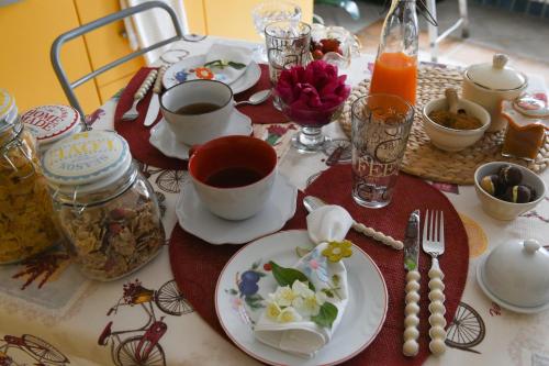 a table with plates and cups of tea on it at B&B Va...lentina in Piavata